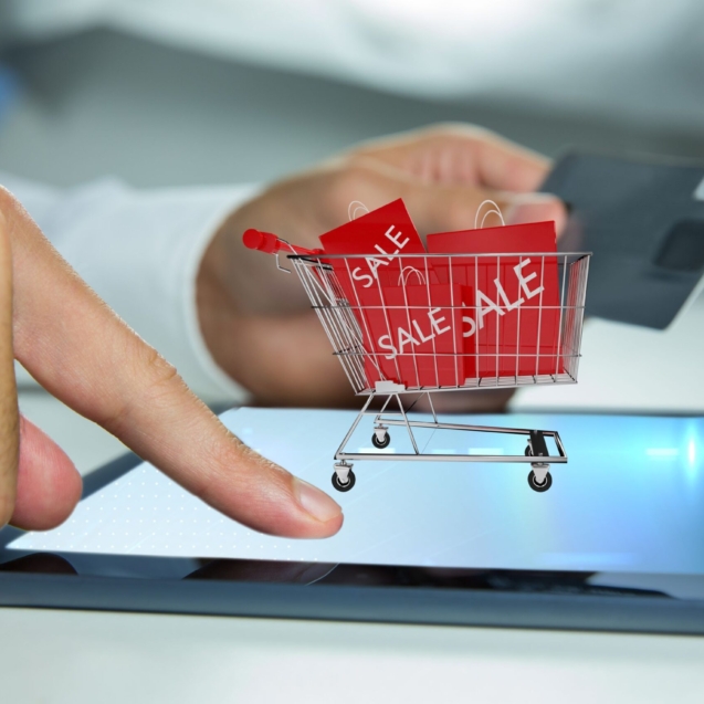 man-playing-tablet-with-shopping-cart (1)